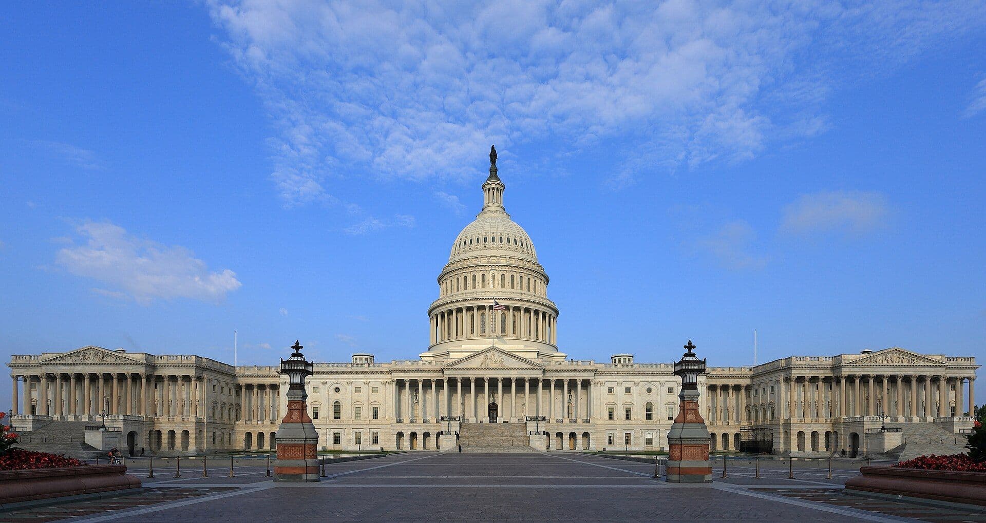 The U.S. Capitol building viewed from its plaza under a blue sky