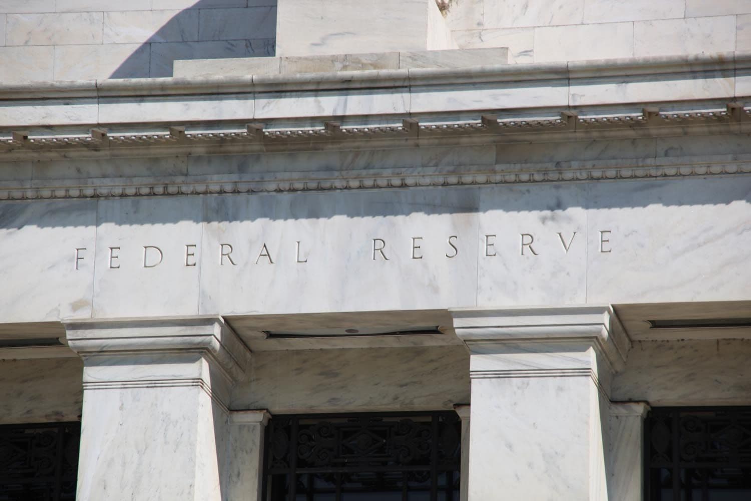 Carved 'Federal Reserve' text on marble entablature of neoclassical Federal Reserve building