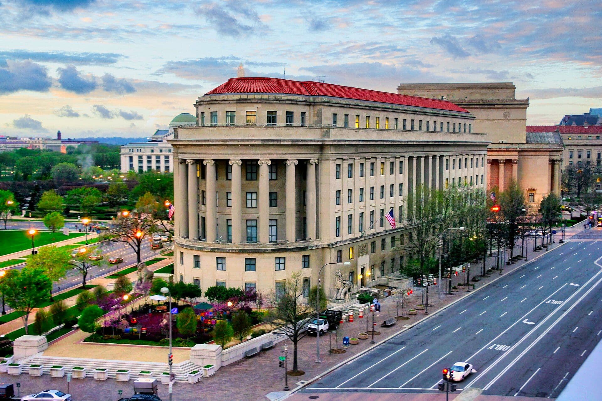 Exterior of the FTC's Apex Building headquarters at dusk with distinctive red roof
