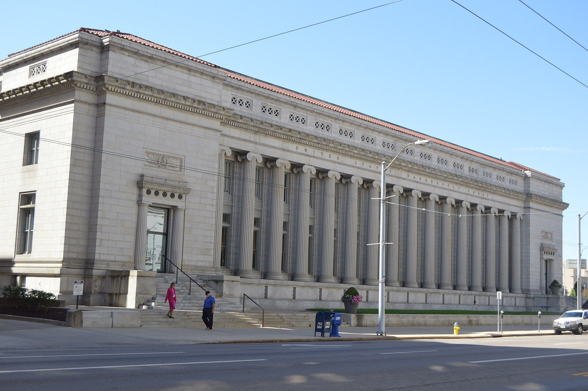 Neoclassical courthouse with white columns and stone facade on a city street