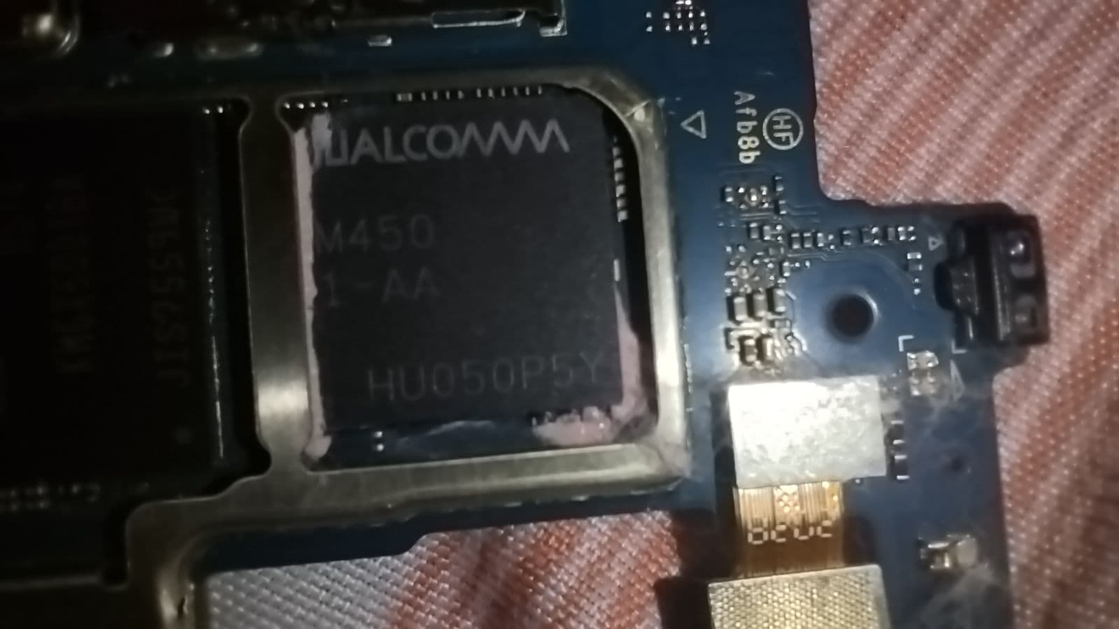 Close-up of a Qualcomm processor on a blue circuit board