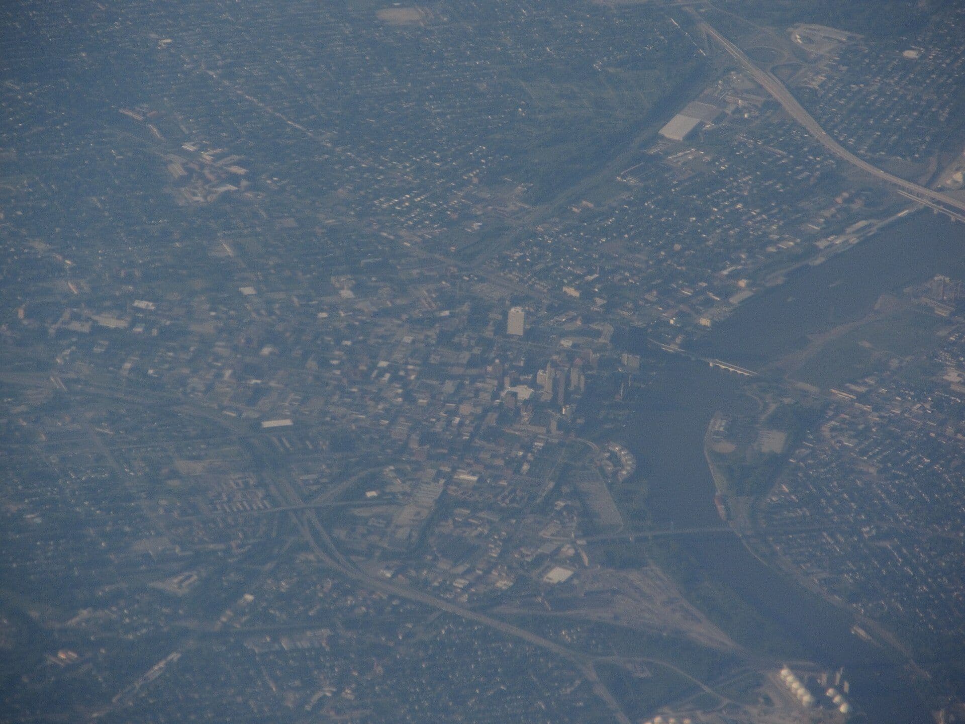 Aerial view of Toledo, Ohio showing downtown buildings, industrial infrastructure, roads, and waterways